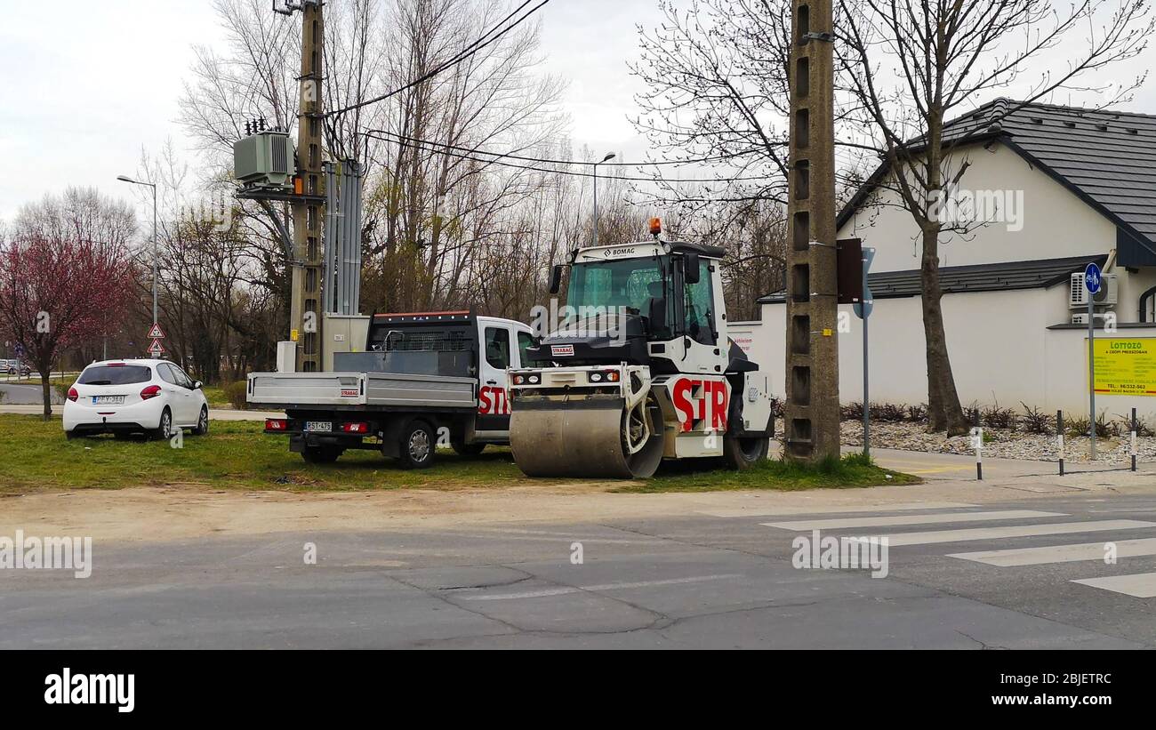 Gyor Hongrie 03 17 2020: Un rouleau routier strabag et un camion se tiennent sur le côté de la route. Banque D'Images
