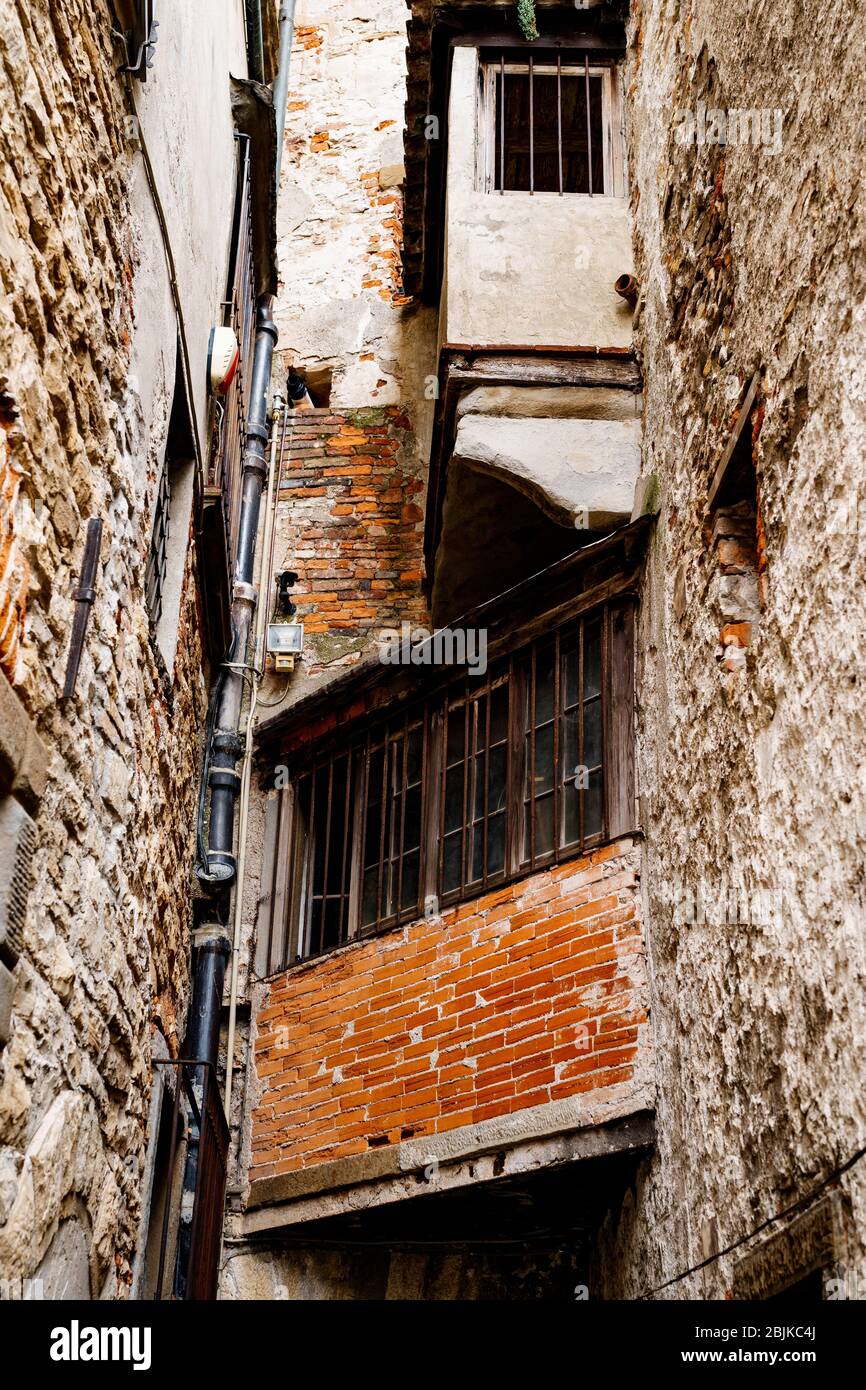 Un petit balcon d'angle entre les rues, avec une vue médiocre depuis la fenêtre. Balcon en briques rouges laides maison Banque D'Images