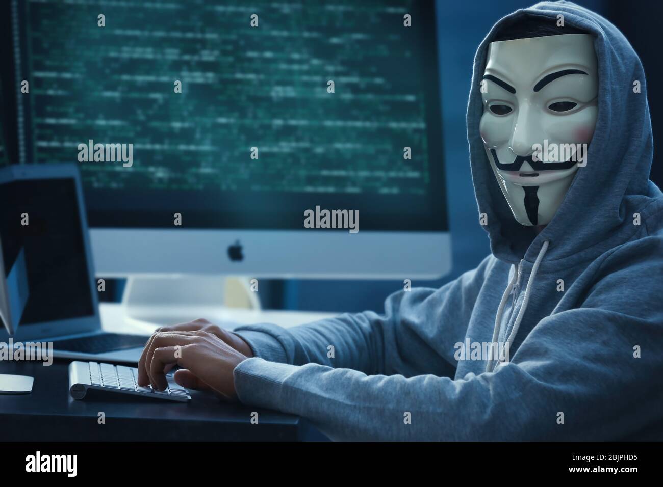 MYKOLAIV, UKRAINE - 29 SEPTEMBRE 2017: Personne anonyme dans le masque Guy Fawkes utilisant l'ordinateur à l'intérieur Banque D'Images