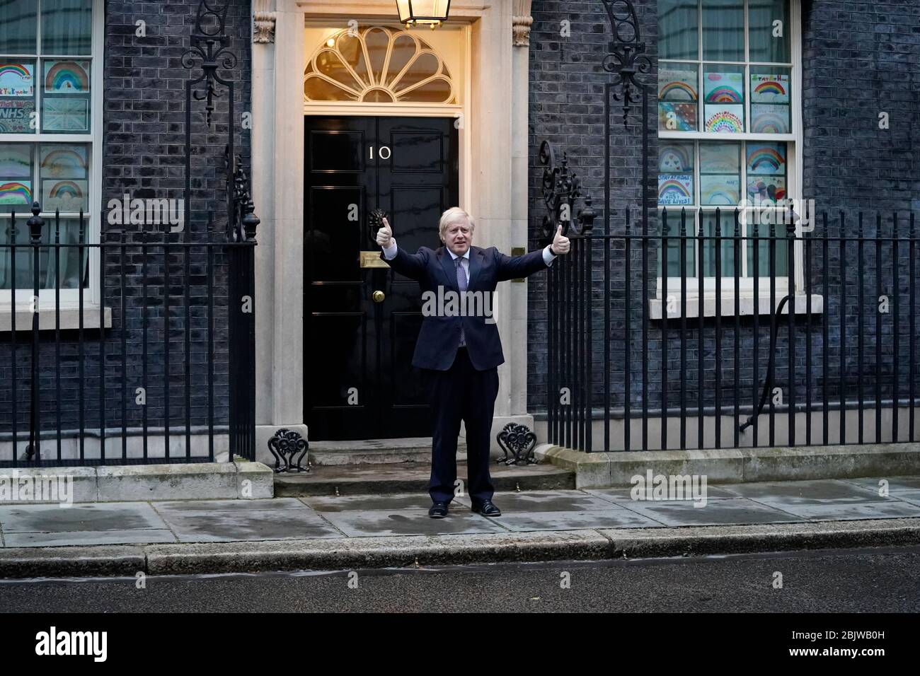 Le Premier ministre Boris Johnson à l'extérieur du 10 Downing Street à Londres se joint aux applaudissements pour saluer les héros locaux du Clap national de jeudi pour que les carrier reconnaissent et soutiennent les travailleurs et les soignants du NHS qui luttent contre la pandémie de coronavirus. Banque D'Images