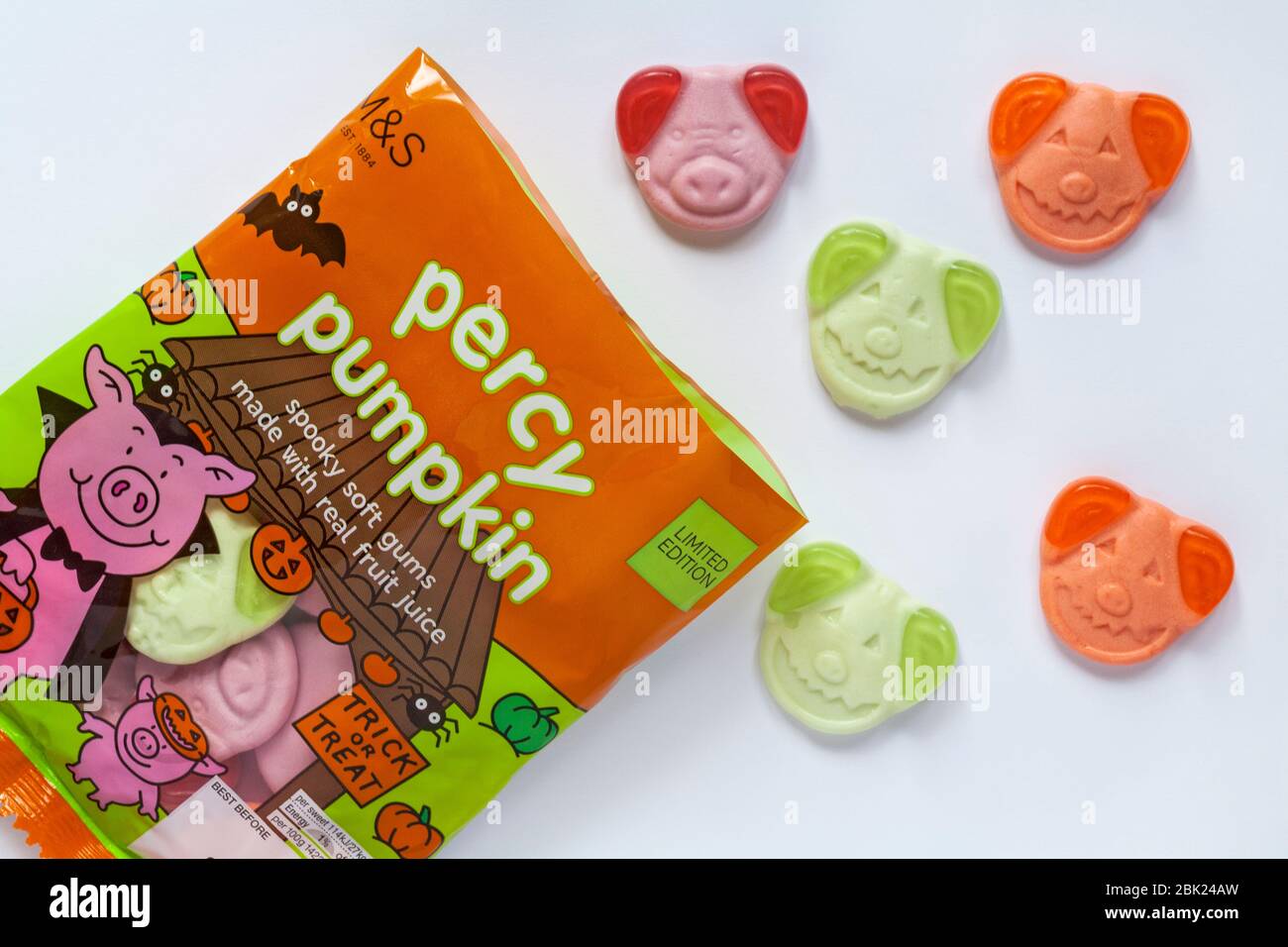 Ouvrir le sachet de M&S Percy bonbons citrouille spooky gommes avec du vrai jus de fruits prêts à trick or treat Halloween avec contenu renversé sur white Banque D'Images