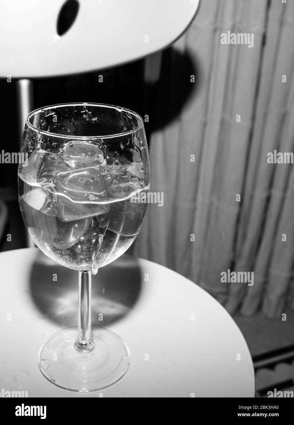 Verre vide avec des cubes de glace sur fond blanc Banque D'Images