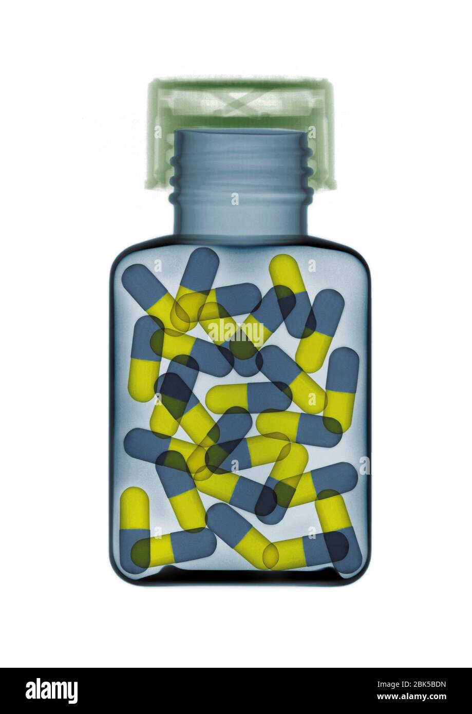 Pilules bleues et jaunes dans une bouteille, rayons X colorés. Banque D'Images