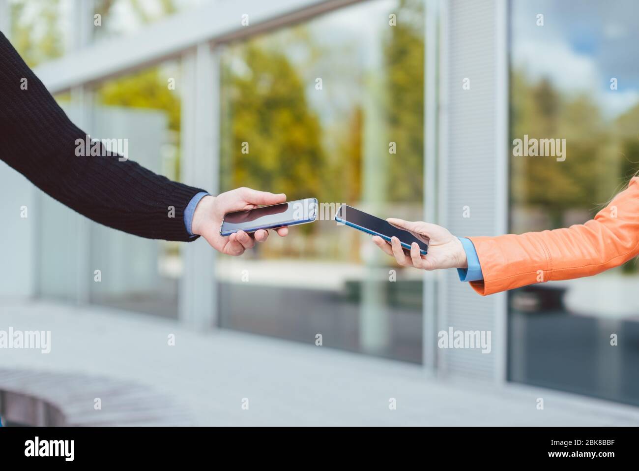 Femme et homme avec application de traçage de contact sur leur téléphone Banque D'Images