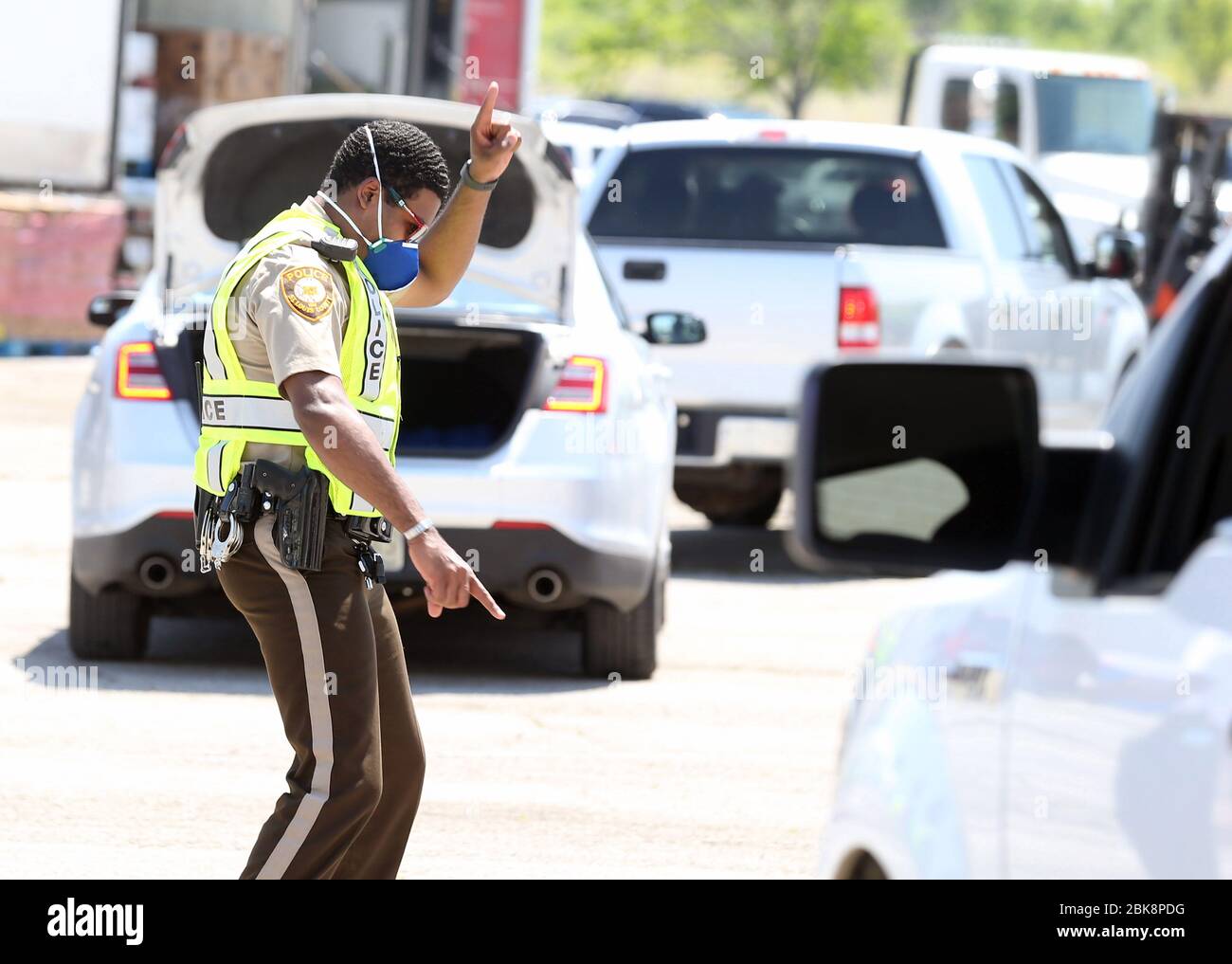 Florissant, États-Unis. 02 mai 2020. Un policier du comté de Saint-Louis fait une danse alors qu'il dirige les voitures vers les aires de chargement de l'ancien centre commercial Jamestown à Florissant, Missouri, le samedi 2 mai 2020. La Ligue urbaine de la Metropolitan St. Louis dit que le service de restauration, à 2 700 véhicules, est le plus important service de restauration à ce jour dans la région de Saint-Louis. Photo de Bill Greenblatt/UPI crédit: UPI/Alay Live News Banque D'Images