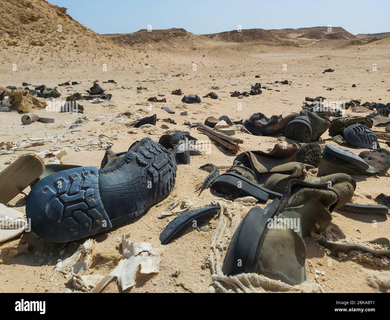 Gros plan sur les vieilles bottes militaires en décaissement abandonnées dans le désert africain éloigné Banque D'Images
