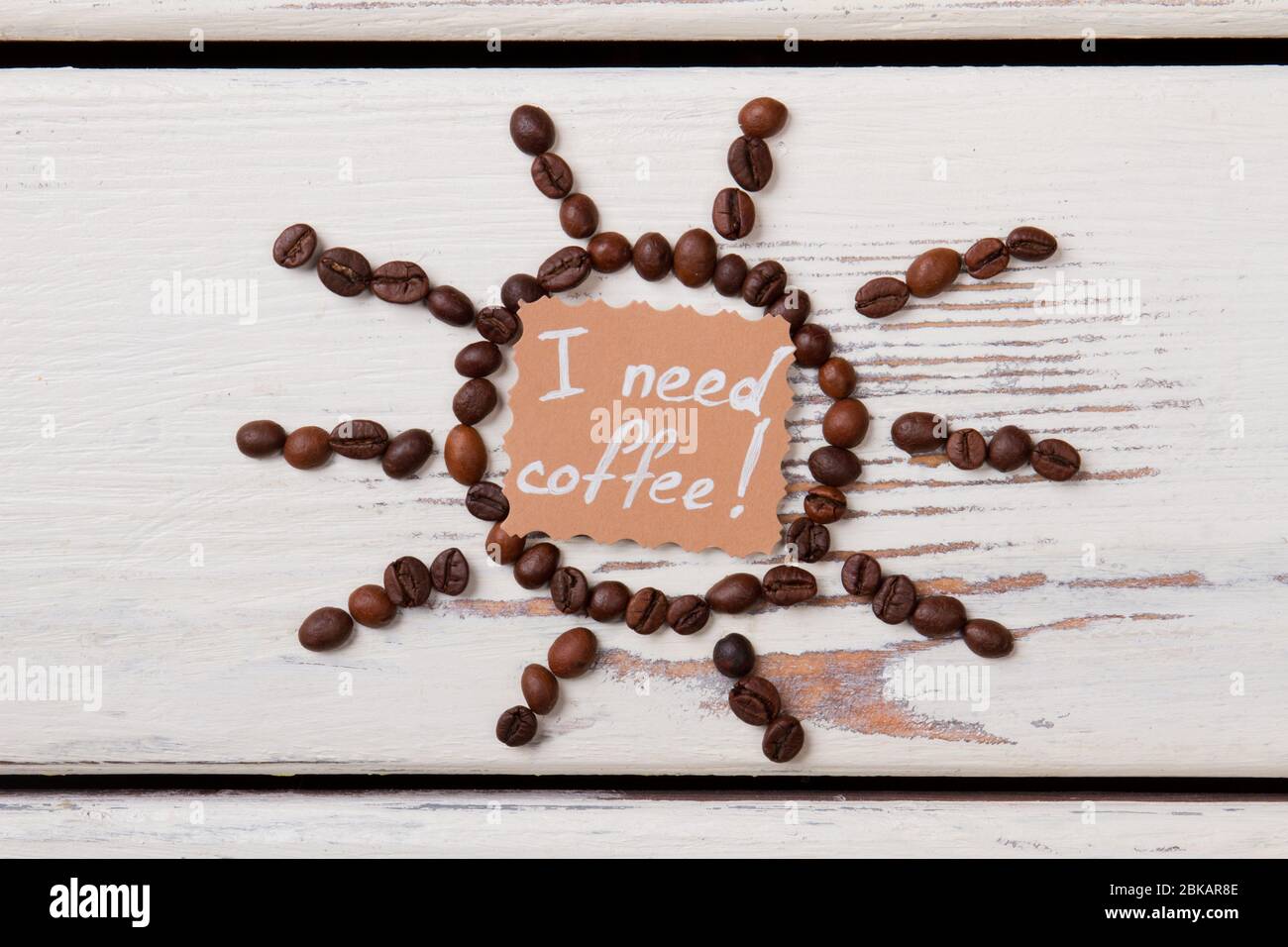 Soleil et papier à grains de café avec j'ai besoin de l'écriture de café. Banque D'Images Soleil et papier à grains de café avec j'ai besoin de l'écriture de café. Banque D'Images