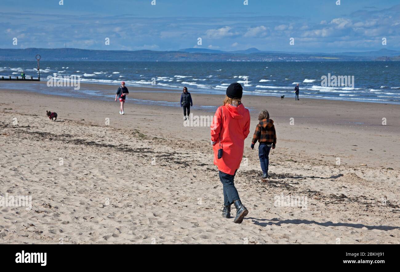 Portobello, Édimbourg, Écosse, Royaume-Uni, 5 mai 2020. La température de la brise ensoleillée, mais fraîche, est d'environ 14 degrés centigrade sur une promenade et une plage la plus calme, avec deux patrouilles par des véhicules de police en l'espace de dix minutes. Les cyclistes semblent toujours prendre le contrôle des patchs de la passerelle, ce qui rend difficile pour les piétons de toujours garder leur distance sociale des autres. Quelques chiens extrêmes s'excroquant sur la plage de sable par quelques propriétaires de chiens et leurs animaux de compagnie. Crédit: Arch White/Alay Live News Banque D'Images