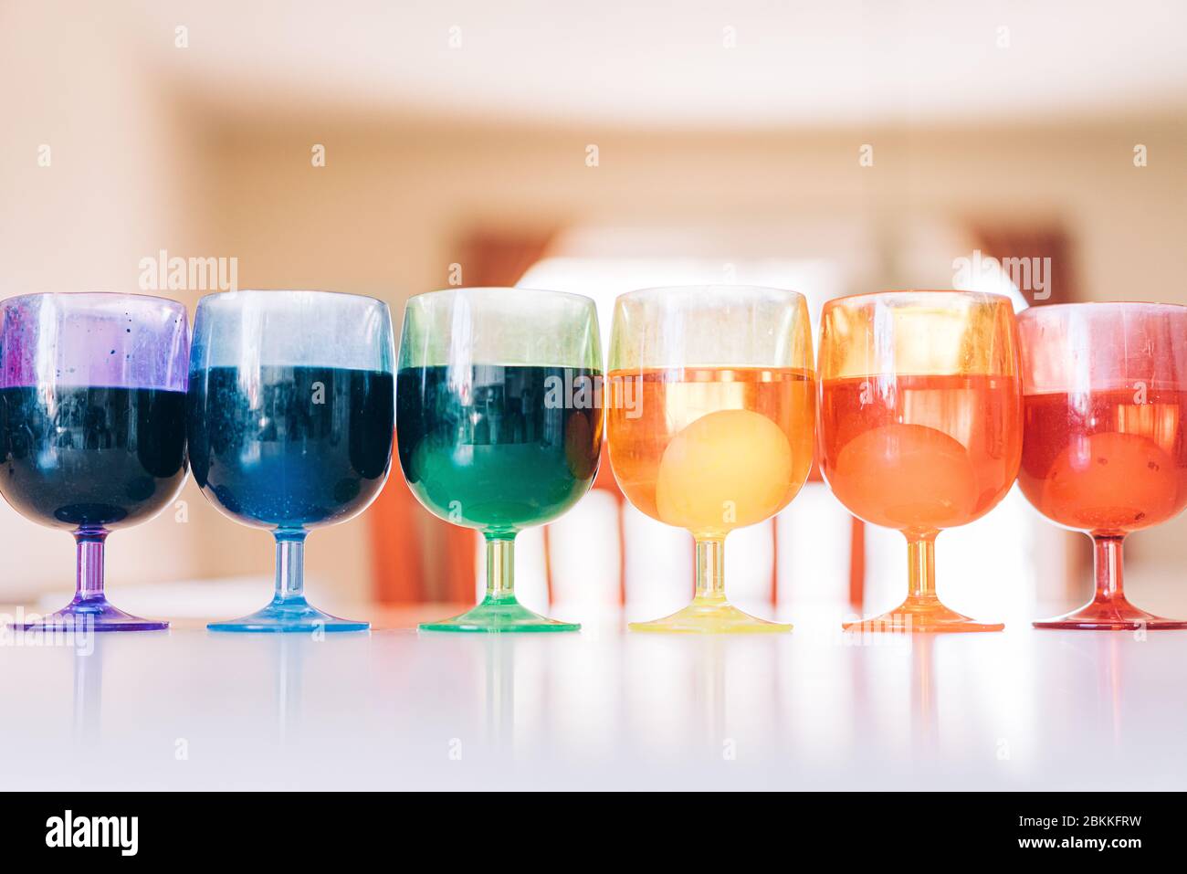 Gamme arc-en-ciel de tasses avec des colorants d'oeufs de pâques Banque D'Images