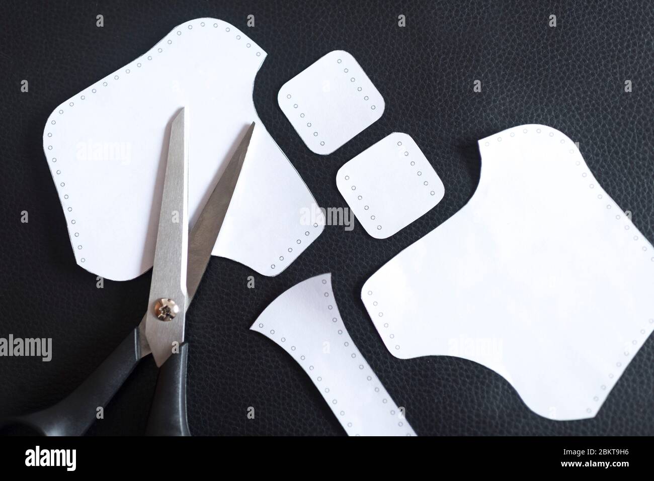 Modèles de papier sur cuir synthétique et ciseaux. Matériaux pour