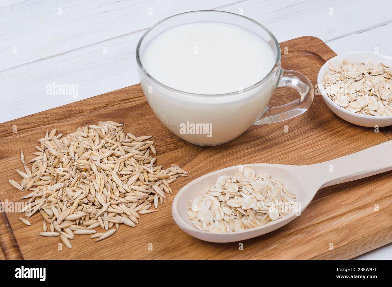 Lait de flocons d'avoine avec graines d'avoine sur fond de bois. Plats végétariens Banque D'Images
