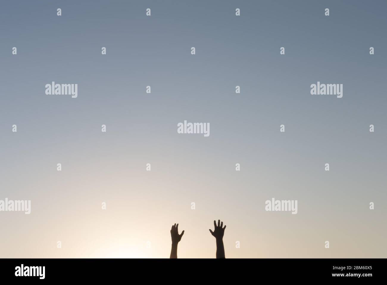 Les bras et les mains mâles se retrouvant dans le ciel au bas de la photo. Modification minimale Banque D'Images