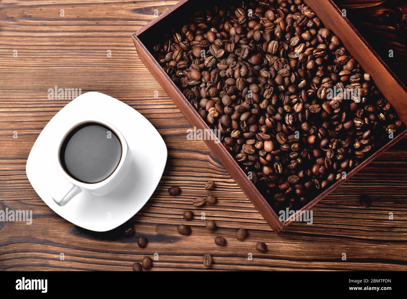 tasse à café blanche, café léger du matin, boîte en bois avec café, vue sur le dessus fond en bois naturel gros plan Banque D'Images