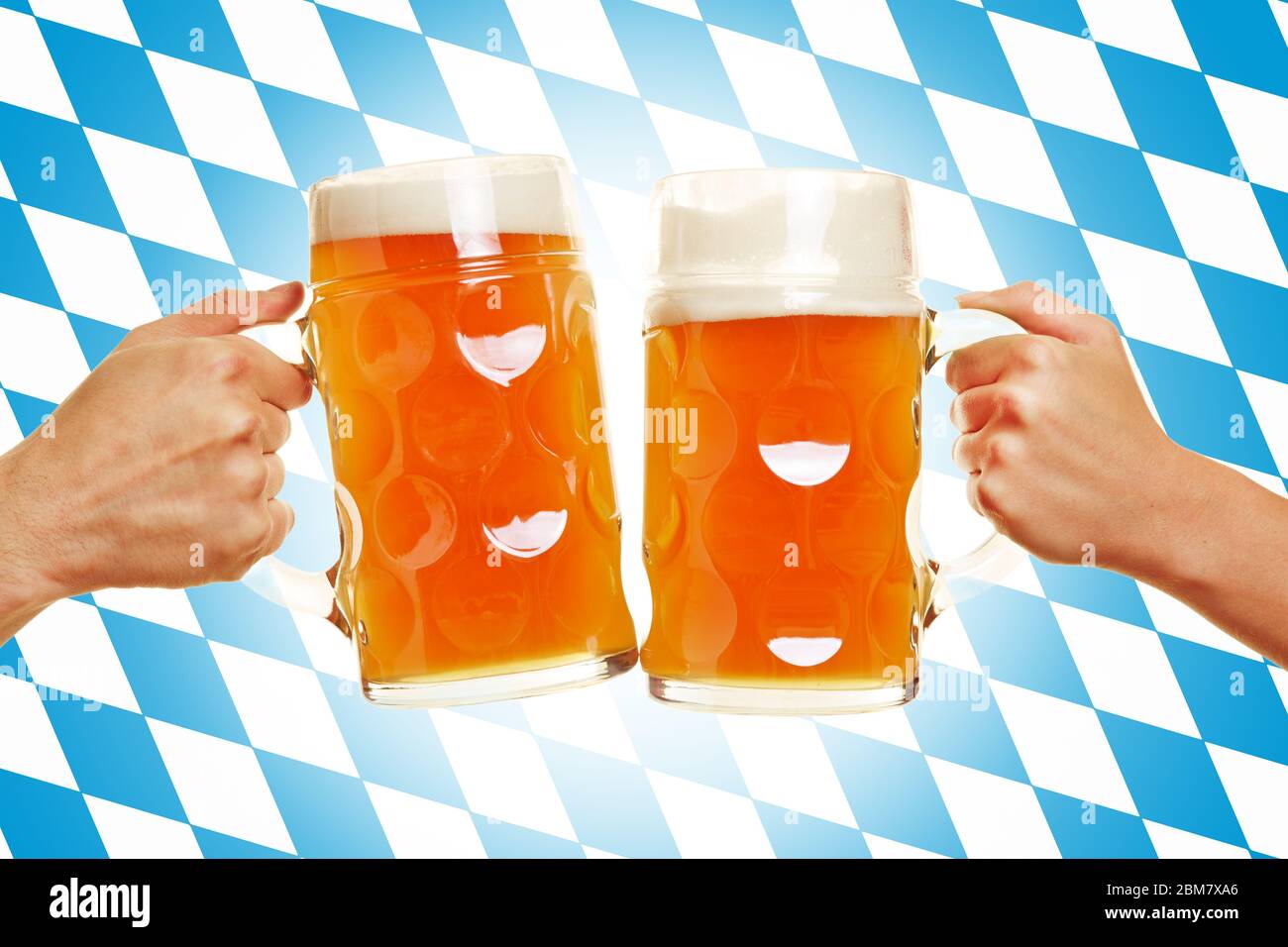 Deux mains claquent des verres de bière devant un drapeau bavarois Banque D'Images
