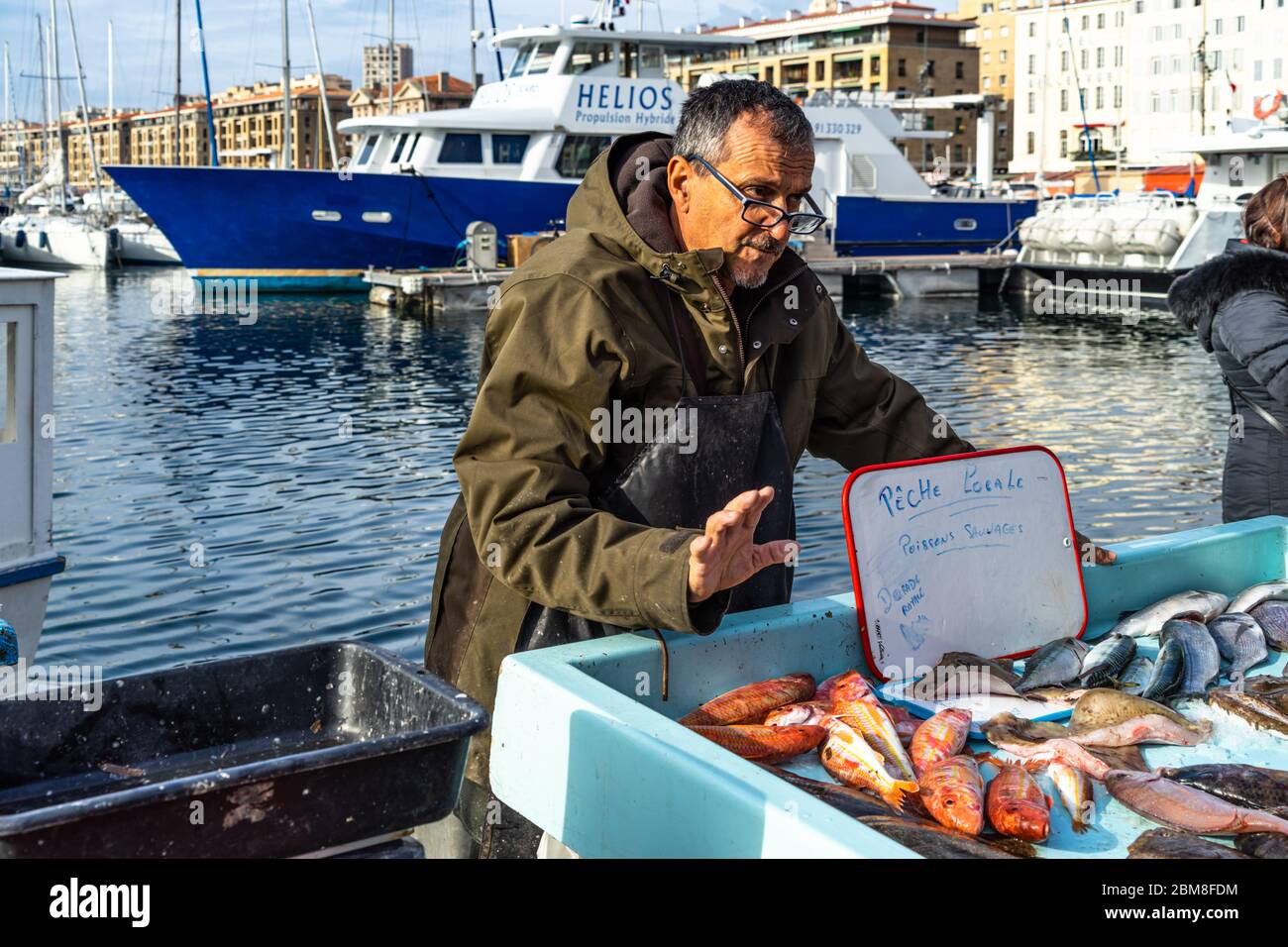 Un pêcheur vendant du poisson frais au marché de poissons de Marseille, une des plus célèbres traditions de la ville et attraction touristique, la France Banque D'Images