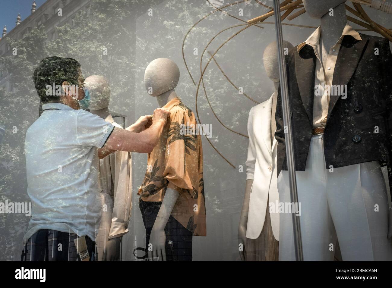 Un styliste de vitrine du groupe Zara / Inditex est vu fixer des vêtements  sur des mannequins pendant la phase zéro du Covid-19. Depuis le 04 mai, le  commerce local a été