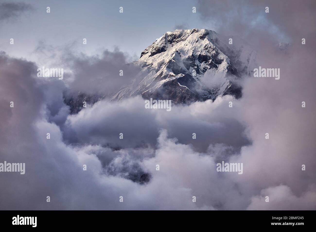 Pointe Sud de l'Annapurna close-up dans le cadre de nuages à coucher du soleil dans le Népal Himalaya Banque D'Images Pointe Sud de l'Annapurna close-up dans le cadre de nuages à coucher du soleil dans le Népal Himalaya Banque D'Images