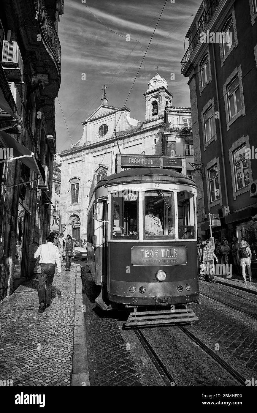 Un tramway passe devant l'église catholique Sainte Marie-Madeleine à Lisbonne, au Portugal. Banque D'Images