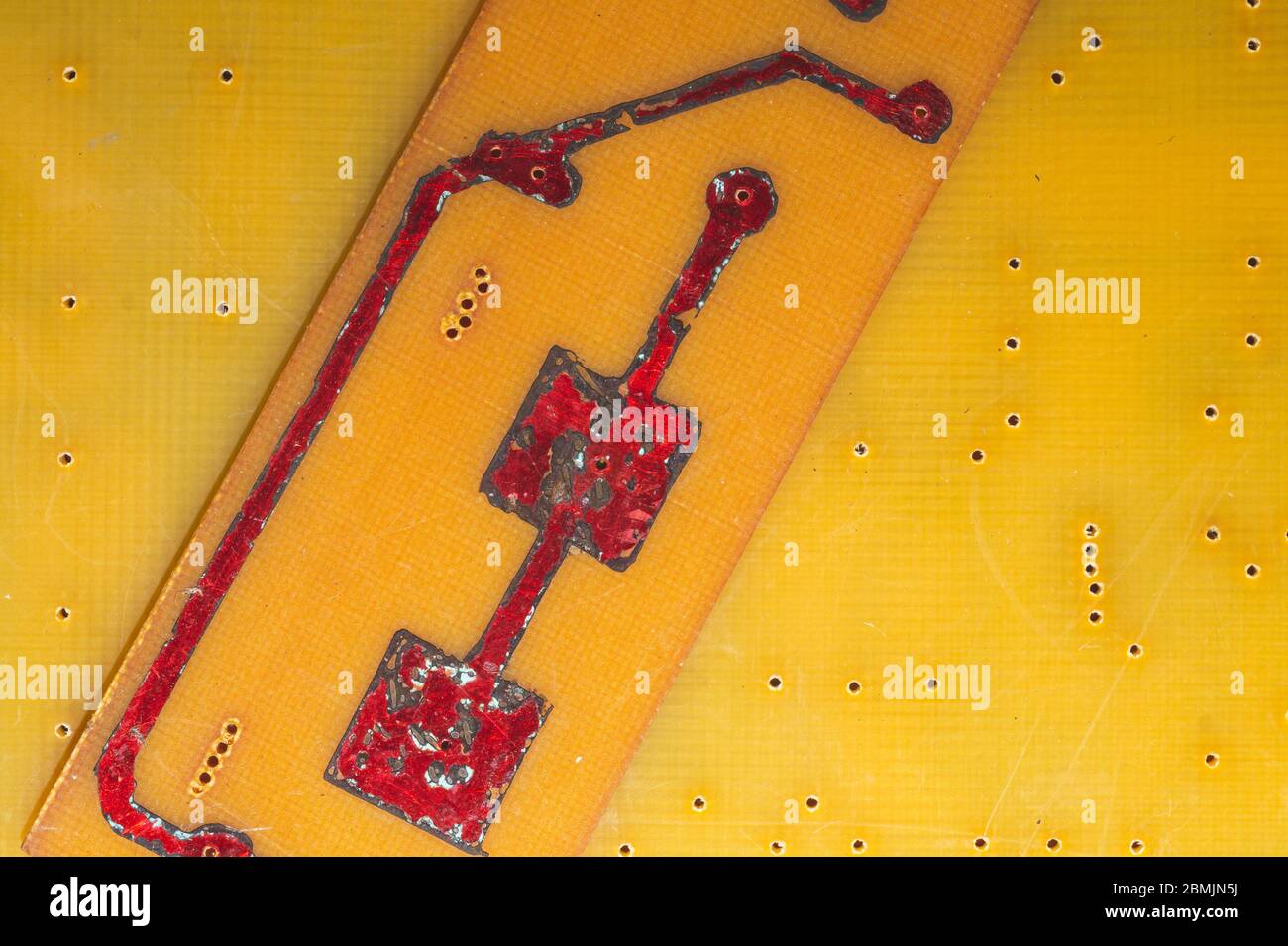 Circuit imprimé fait main avec pistes soudées rouges. Arrière-plan industriel. Textolite avec soudure Banque D'Images