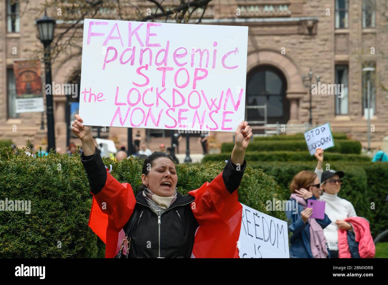 Un manifestant demande la fin de la fermeture de la COVID-19 à l'extérieur de l'édifice de l'Assemblée législative de l'Ontario, à Queen's Park, à Toronto, LE 2 mai 2020. Banque D'Images