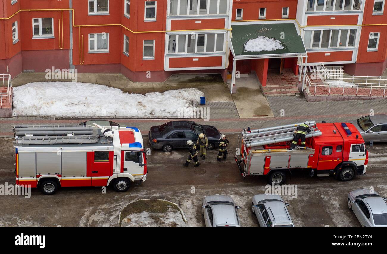 Un feu de cheminée dans la cour d'un immeuble résidentiel de plusieurs étages en hiver. Banque D'Images