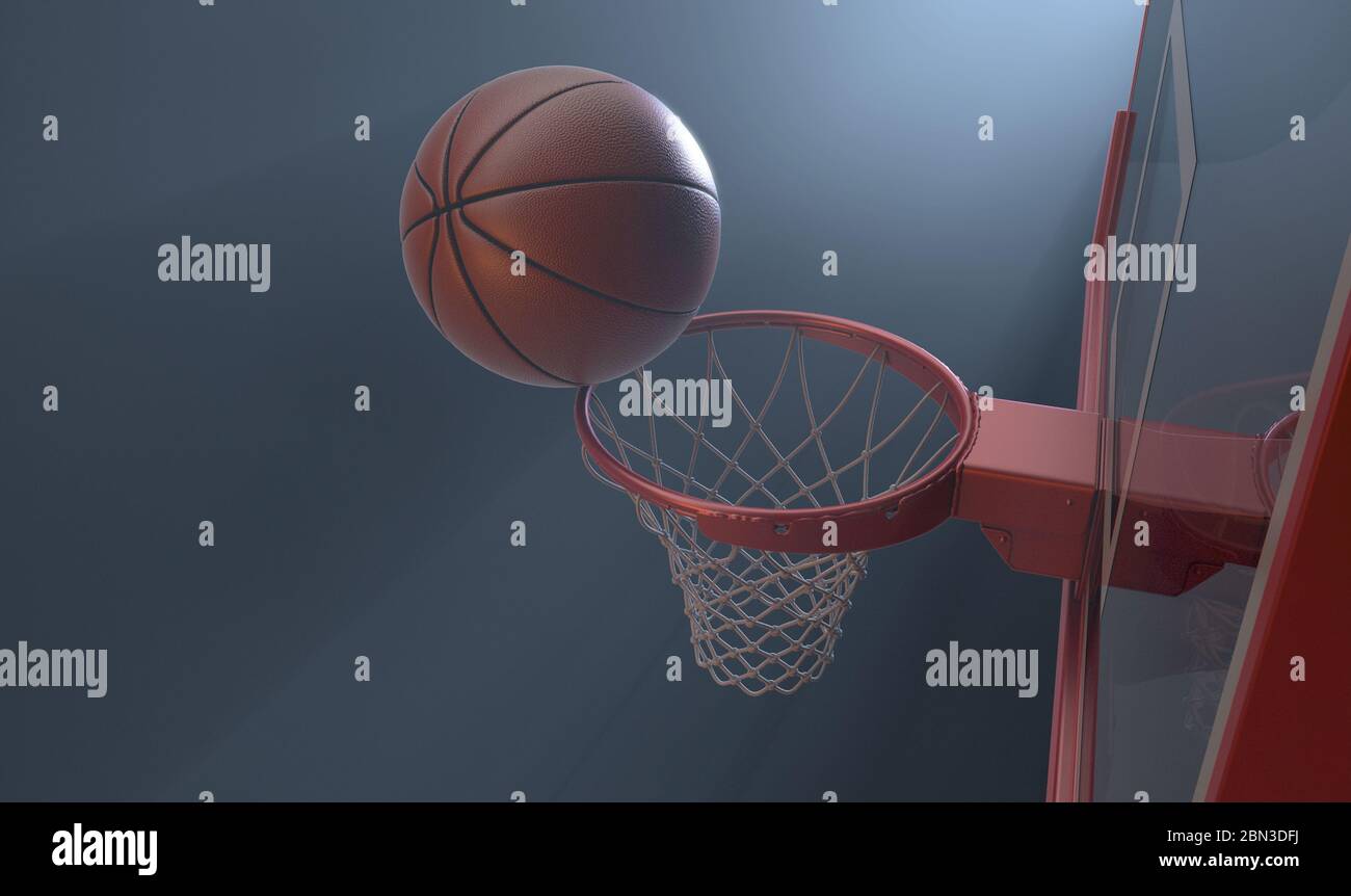 Photo d'action d'un ballon de basket-ball classique qui se joue sur le bord d'un panier de basket-ball rouge et qui est très bien éclairé par l'arrière sur un arrière-plan sombre isolé - Banque D'Images