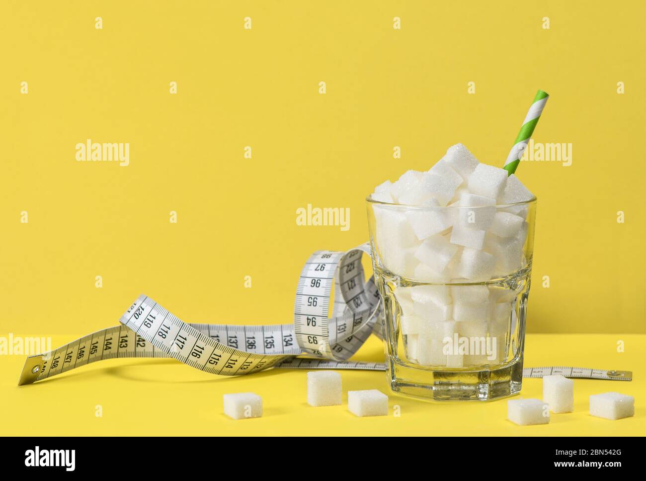 Cubes de sucre en verre et ruban de mesure. Contrôle du poids, régime et concept de détox Banque D'Images