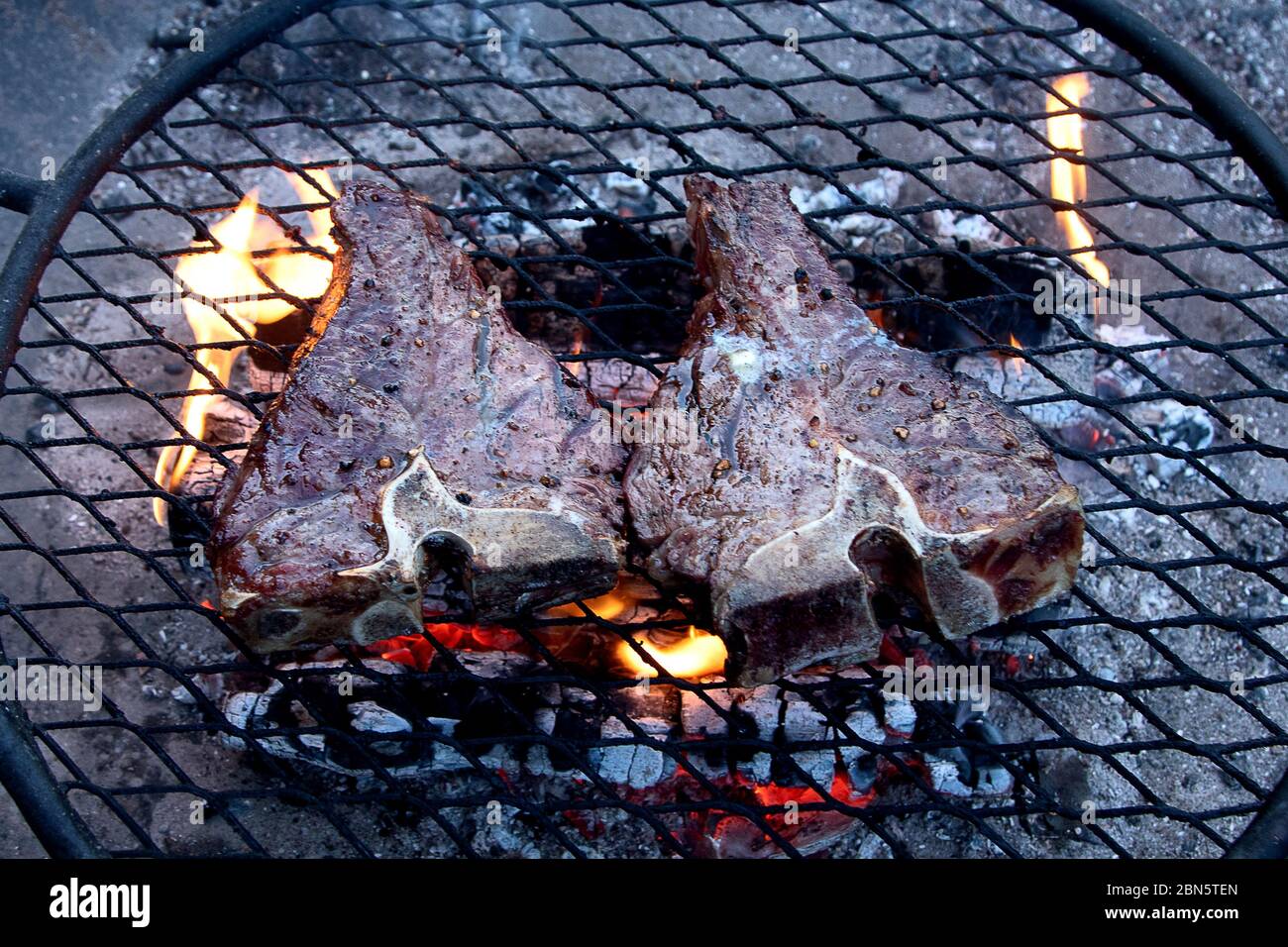 Griller des steaks de bœuf sur un gril flamboyant. Vue de dessus Banque D'Images