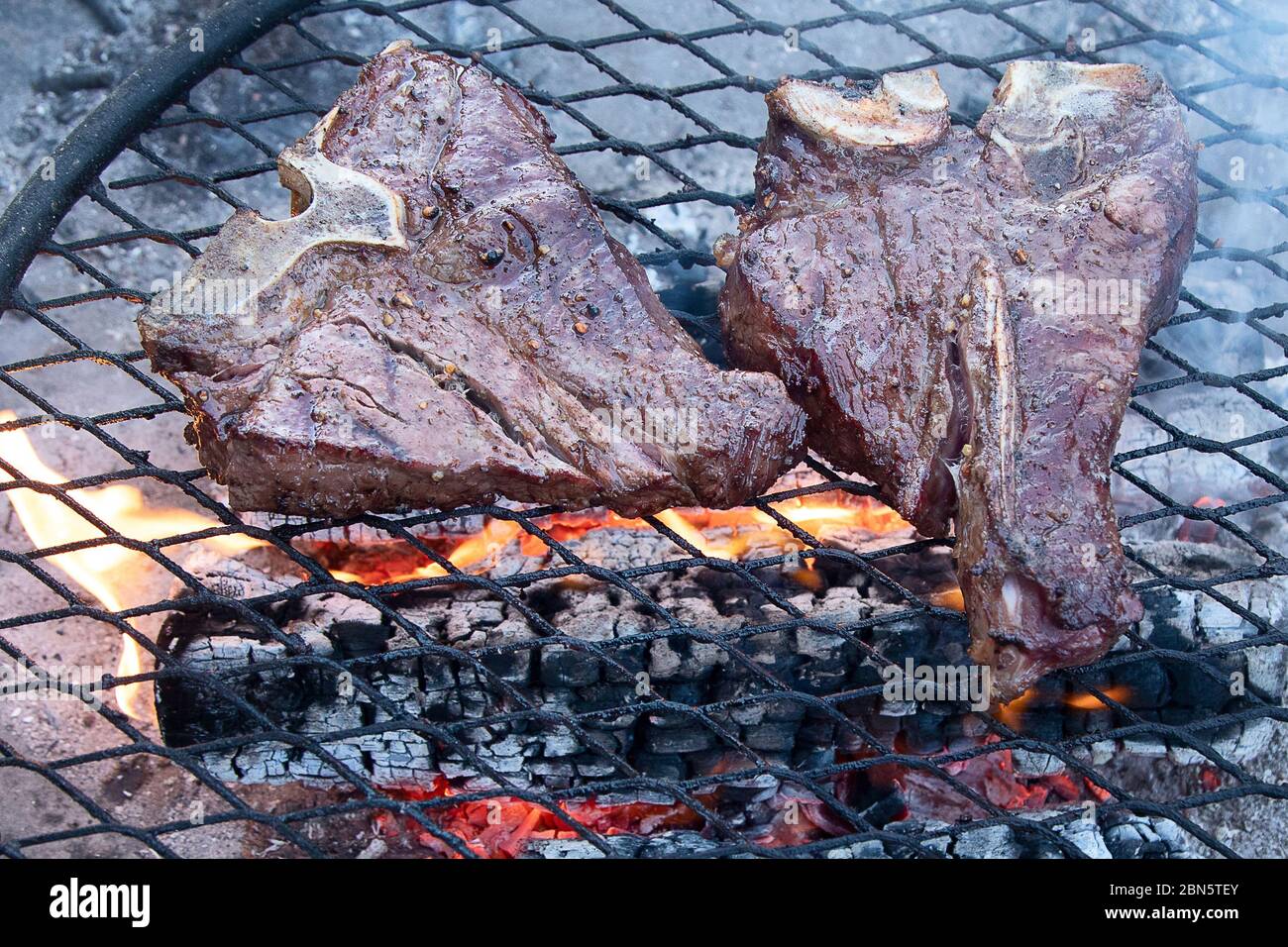 Griller des steaks de bœuf sur un gril flamboyant. Vue de dessus Banque D'Images