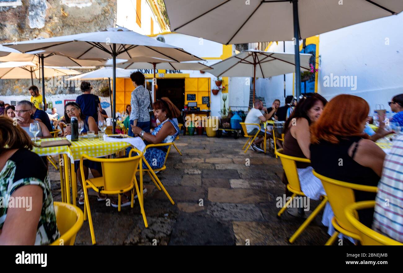 Les gens apprécient le beau temps d'été dans un restaurant en plein air près du Tage à Almada, Portugal Banque D'Images