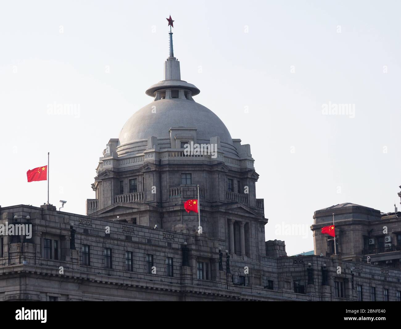 Les drapeaux nationaux sur les bâtiments du Bund sont abaissés en Berne pour pleurer le personnel médical et les citoyens sont morts du coronavirus, Shanghai, Chine, 4 avril 202 Banque D'Images