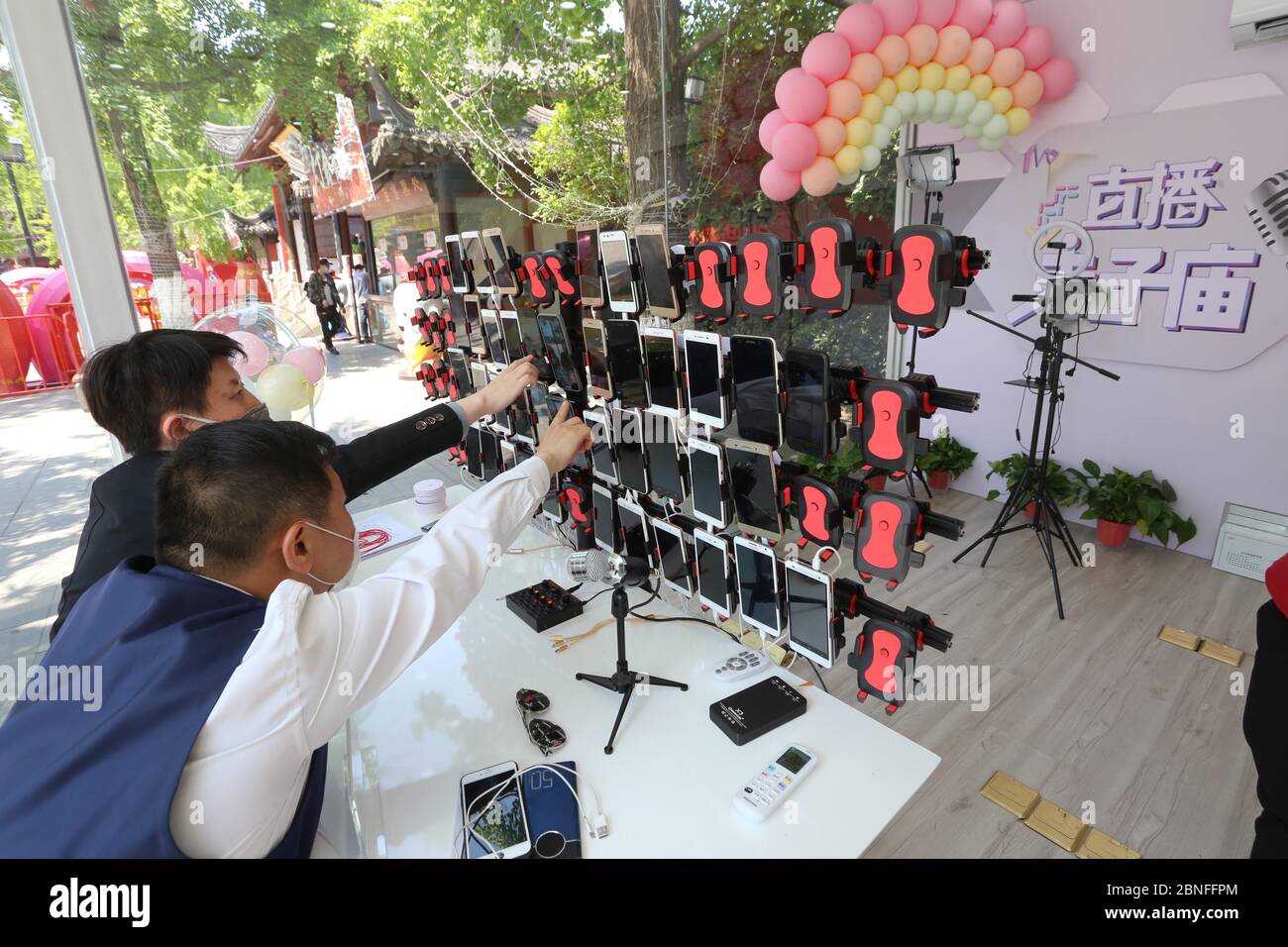 Le personnel ajuste les téléphones pour la diffusion en direct dans la maison de diffusion en direct de verre de Fuzimiao à Nanjing, dans la province de Jiangsu, en Chine orientale, du 29 au 23 avril 2020 Banque D'Images