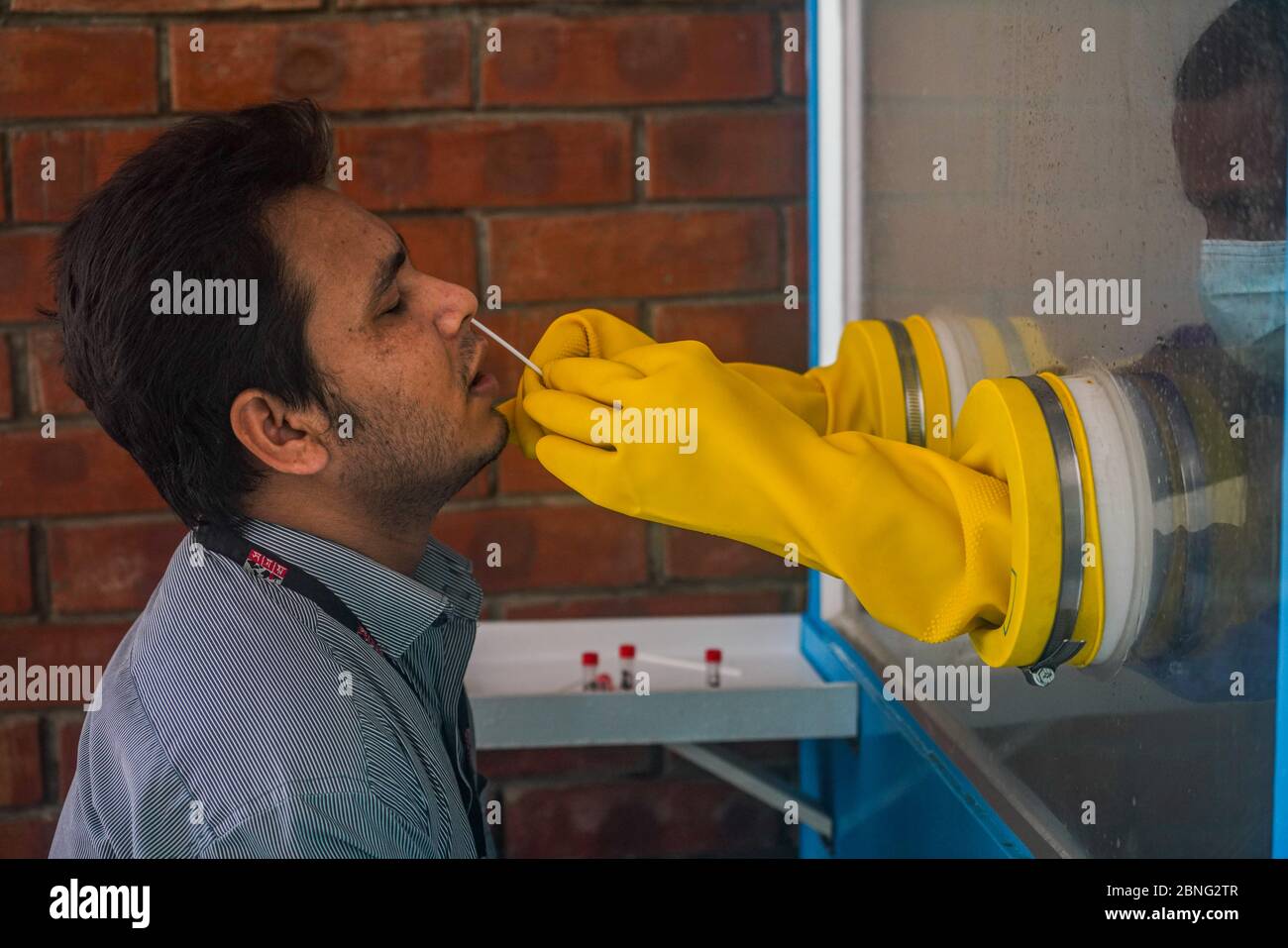 Dhaka, Bangladesh. 13 mai 2020. Un homme qui a recueilli son échantillon par un personnel de santé pendant les tests. L'hôpital universitaire de médecine de Bangabandhu Sheikh Mujib effectue 19 tests sur les bangladais, le ministère de la Santé ayant enregistré 19904 cas confirmés, 3361 cas récupérés et 297 décès par le virus corona. Crédit : SOPA Images Limited/Alamy Live News Banque D'Images