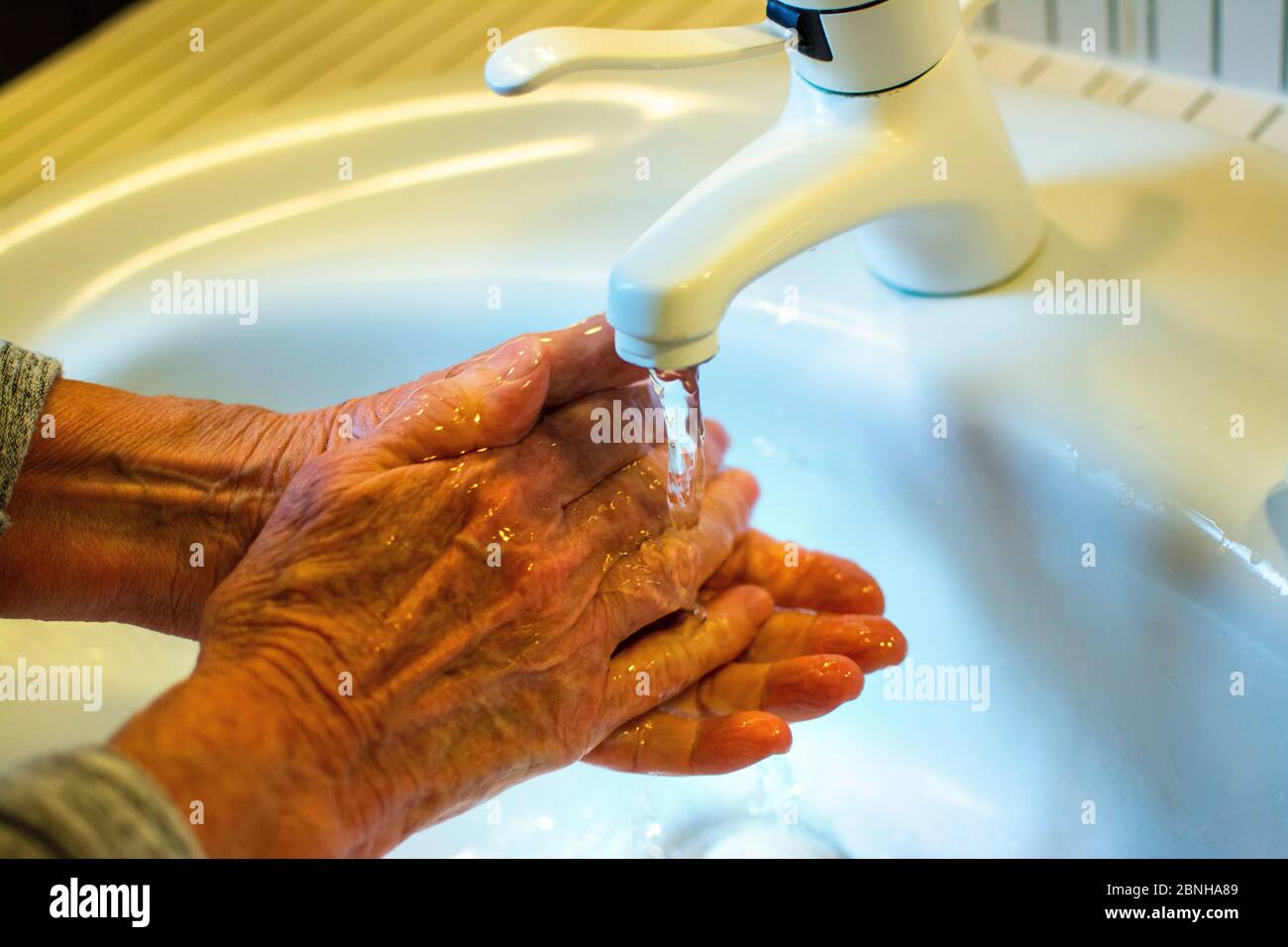 Se laver les mains dans la salle de bains Banque D'Images
