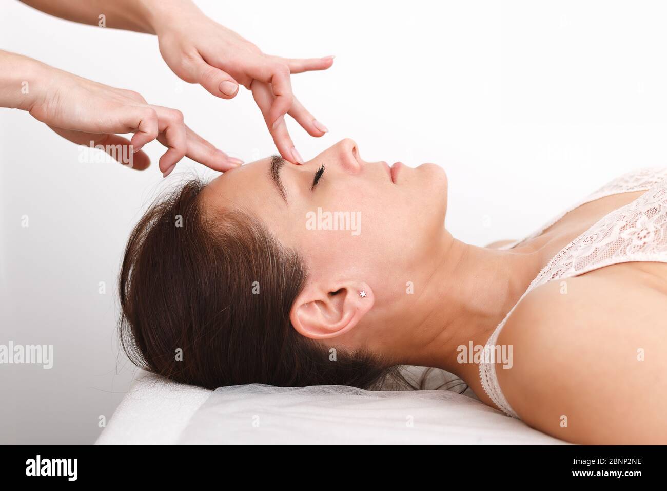 Femme sur le visage procédure de soin de peau, sur le massage contre les  rides, sur fond blanc gros plan. Centre médical ou salon de beauté. Concept  de publicité Photo Stock -