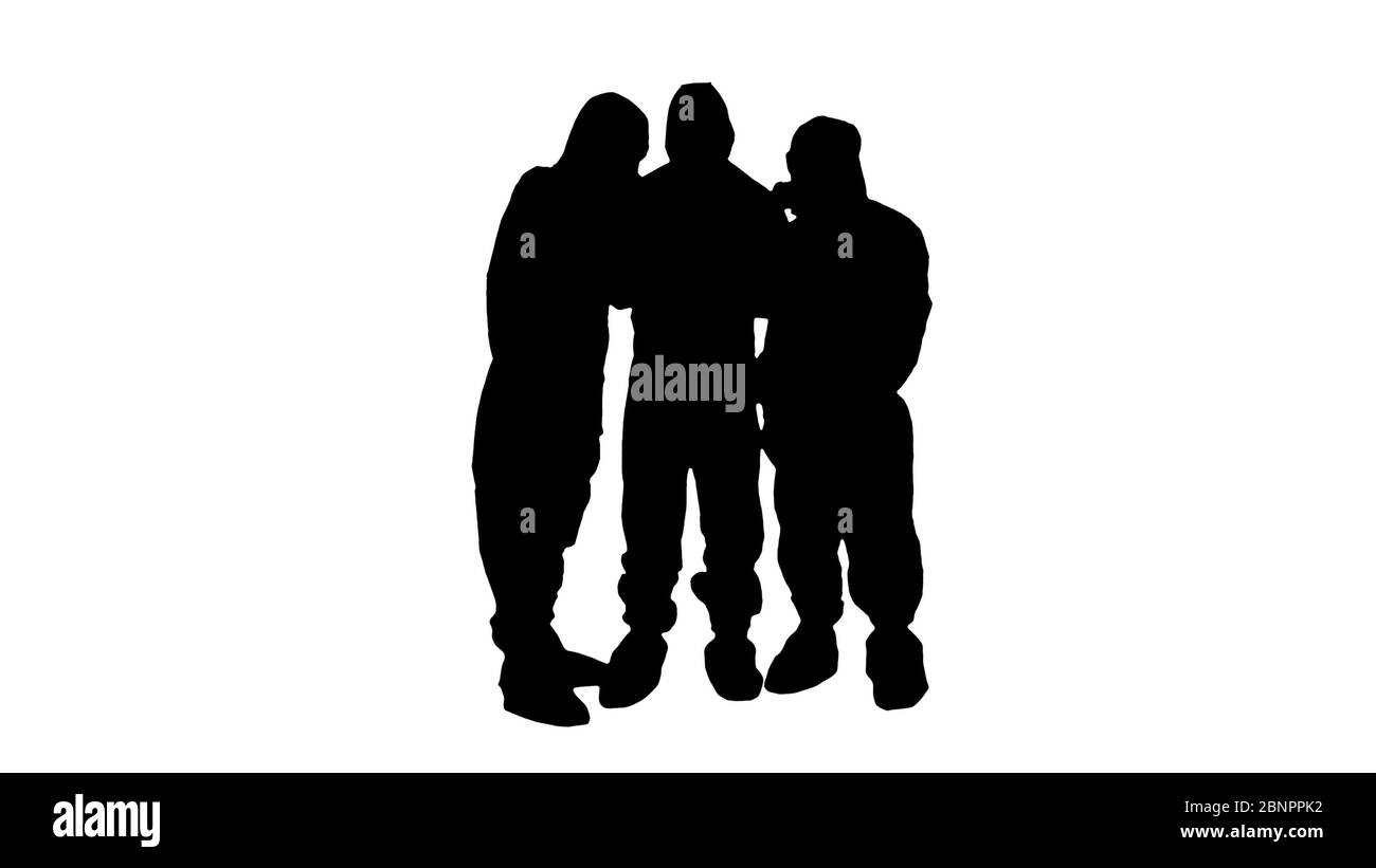 Silhouette médecins ou scientifiques portant des combinaisons de matières dangereuses travaillant ensemble sur une tablette numérique. Banque D'Images