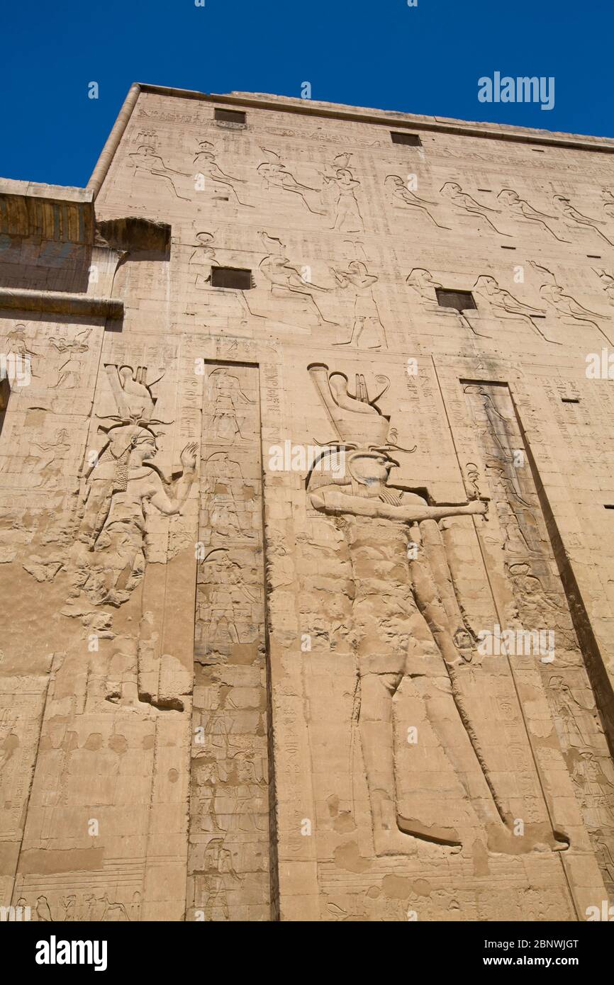 Bas relief de Dieu Horus (à droite), Premier pylône, Temple d'Horus, Edfu, Égypte Banque D'Images