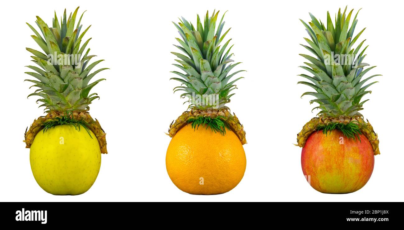 fruits amusants, concept alimentaire créatif. Chapeau d'ananas sur pomme et orange. Base pour dessiner un visage humain amusant. Espace de copie Banque D'Images