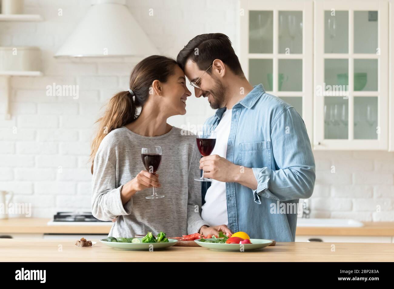 Couple millénaire aimant ayant une date romantique dans la cuisine ensemble Banque D'Images