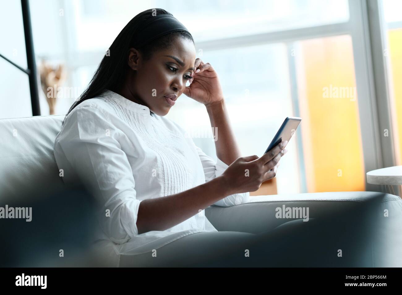 Femme noire frustrée ayant des problèmes avec le smartphone Banque D'Images