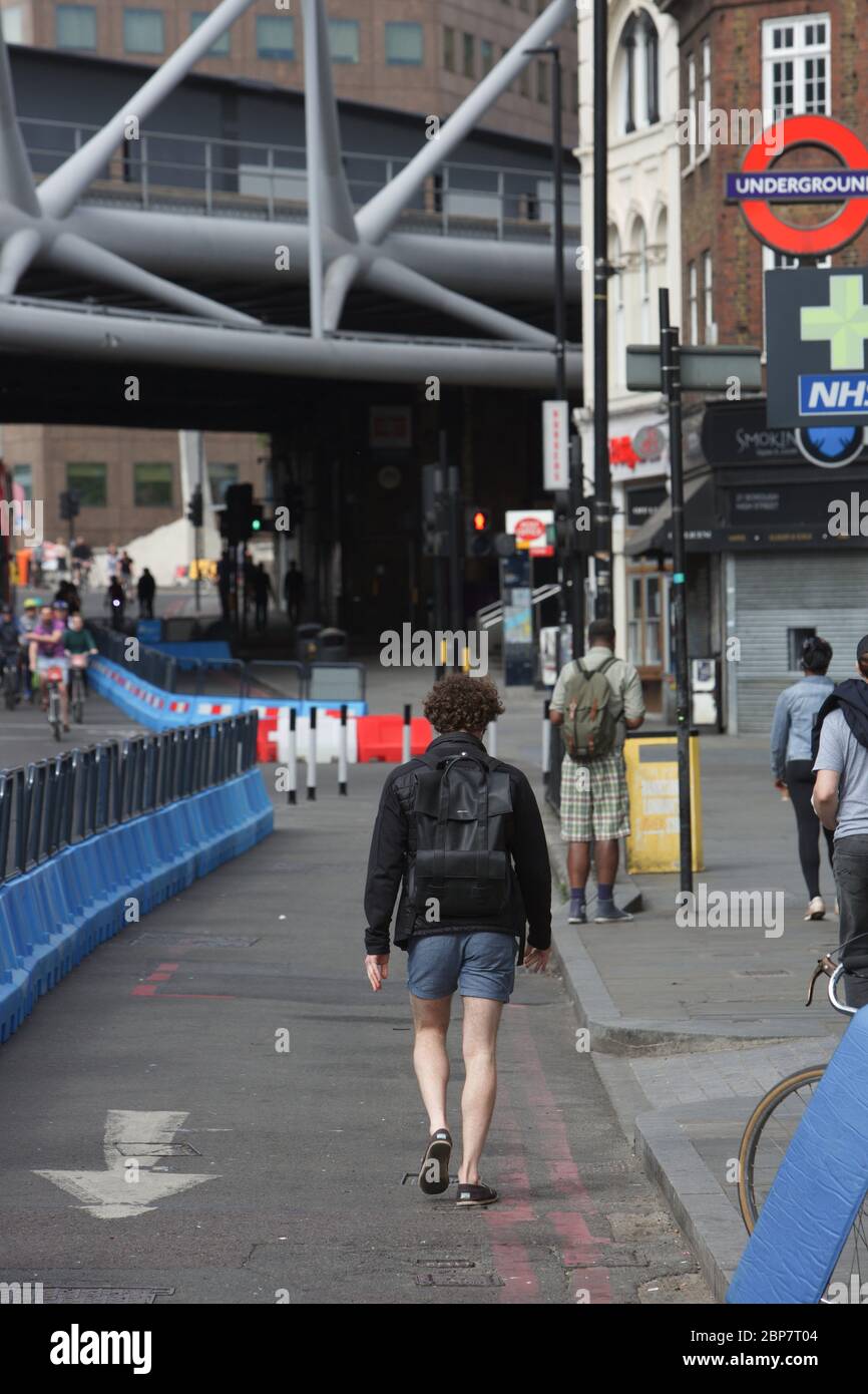 Les piétons et les cyclistes de Londres utilisent de nouveaux trottoirs élargis et des pistes cyclables pendant la pandémie du coronavirus. Quartier High Street, mai 2020. Banque D'Images