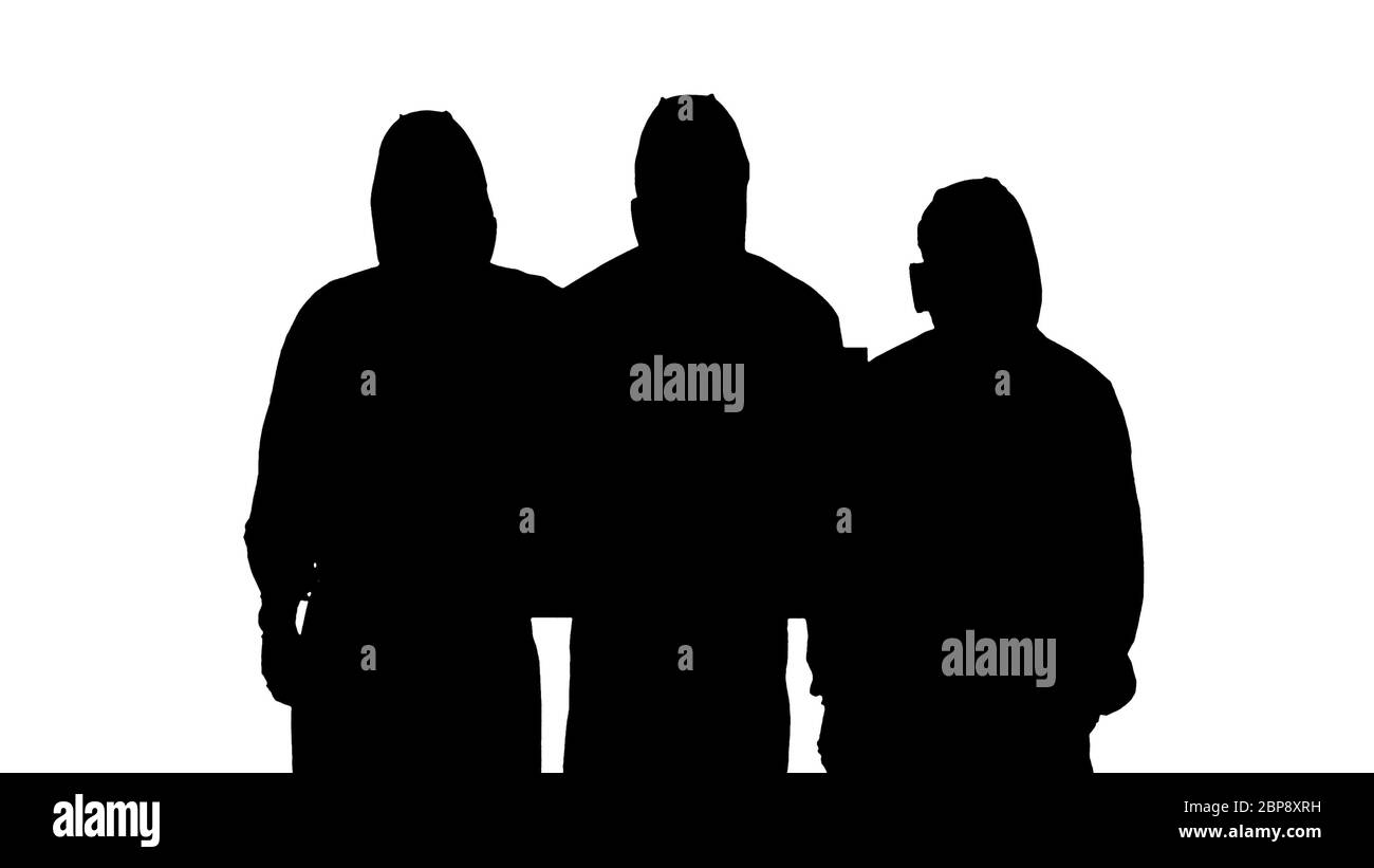 Silhouette trois médecins en combinaisons de protection tenant un panneau vierge. Banque D'Images