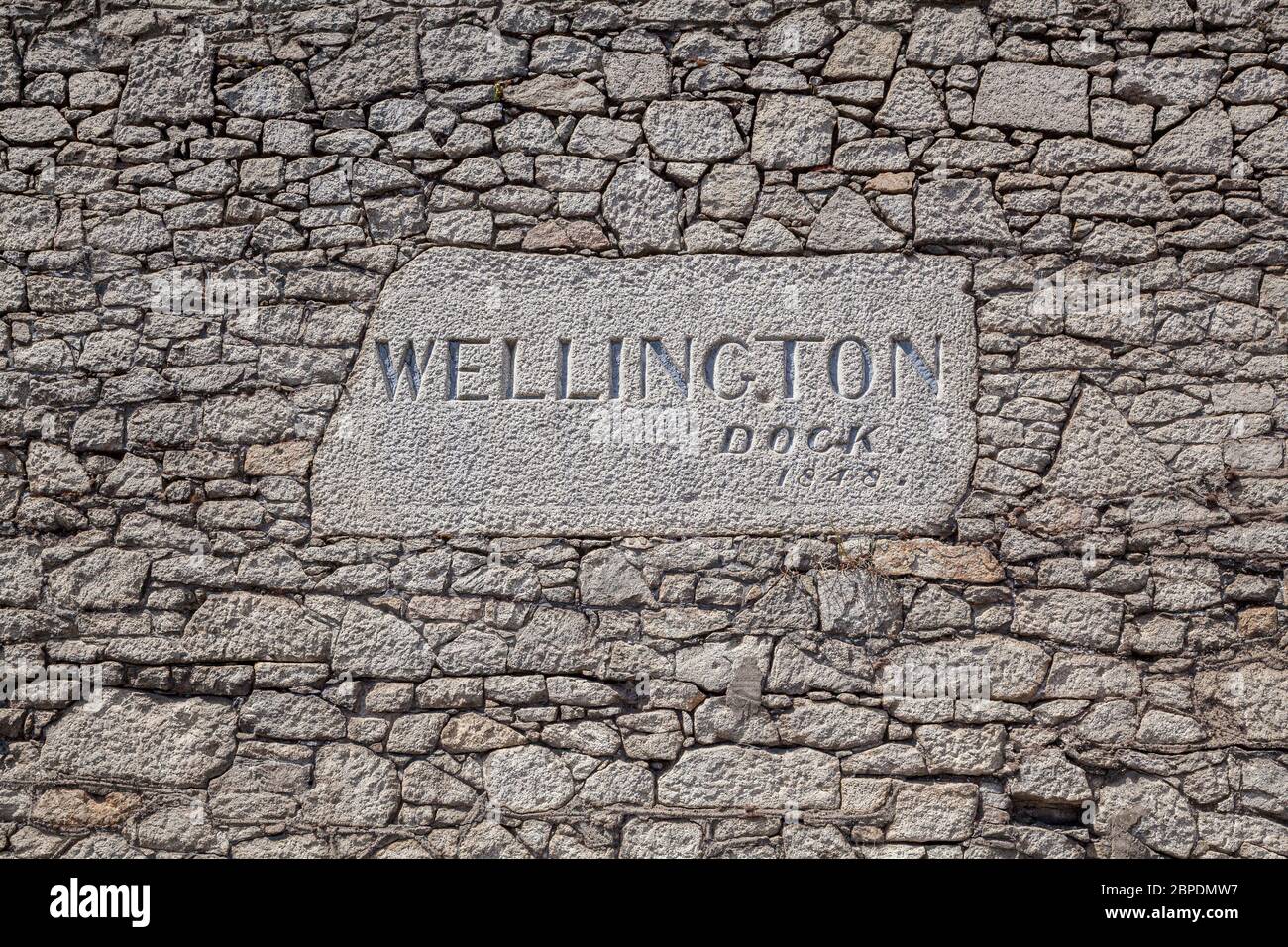 Panneau sur l'ancien mur en pierre du Wellington Dock, partie du port de Liverpool, Angleterre Banque D'Images
