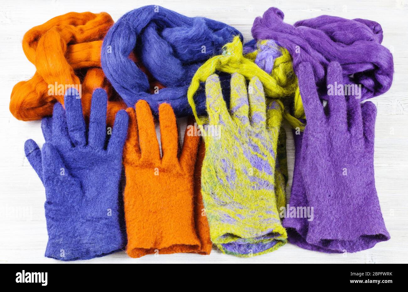 La main de l'atelier faisant un Gants polaire à partir de la laine de mouton à l'aide de feutrage humide - laine feutrée à la main aux couleurs multiples et des gants de laine pour eux Banque D'Images