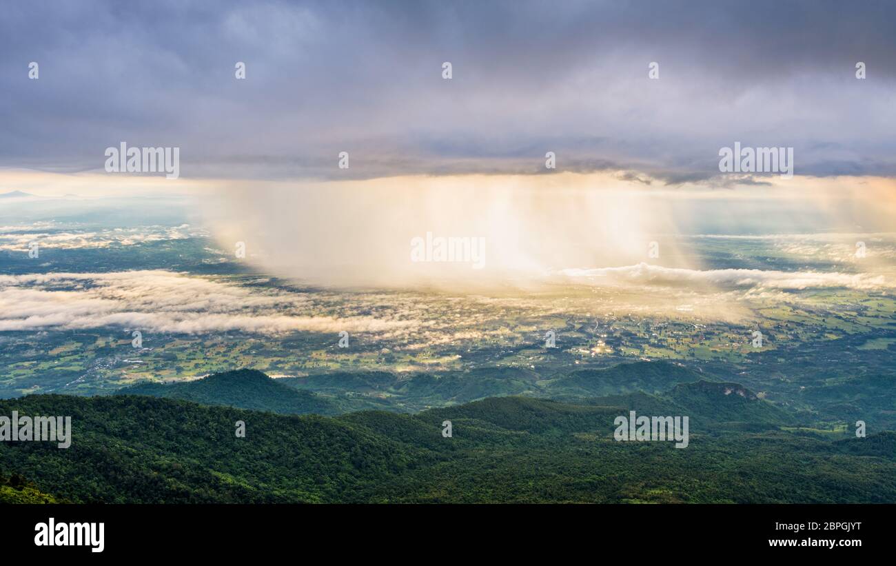 Belle vue sur la grande nature paysage de la montagne et forêt ciel la pluie tombe la lumière du soleil qui brillait à travers est d'or à Phu Thap Berk de vue, Banque D'Images