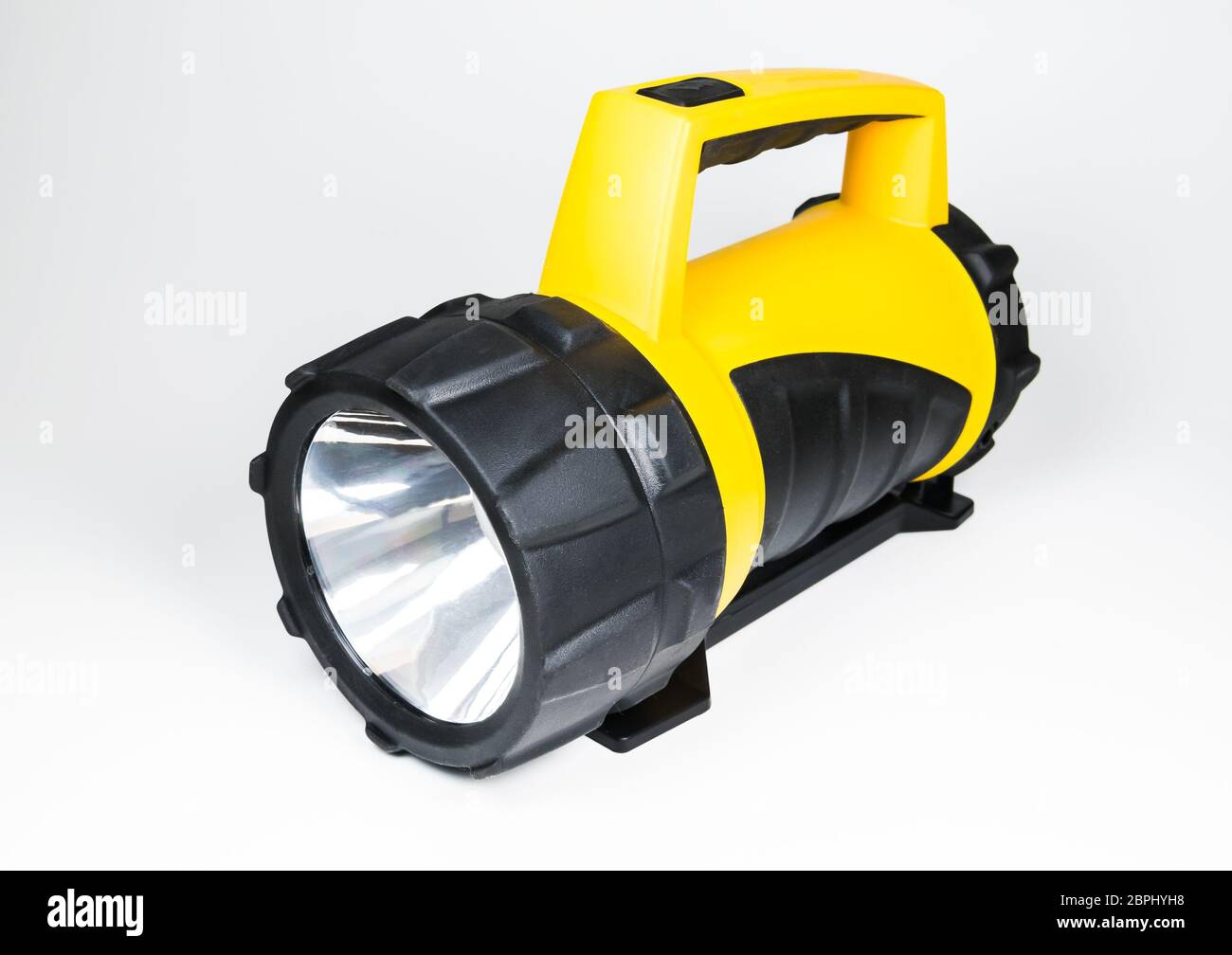 grande lampe de poche jaune à main avec angle réglable isolé sur fond blanc. Banque D'Images