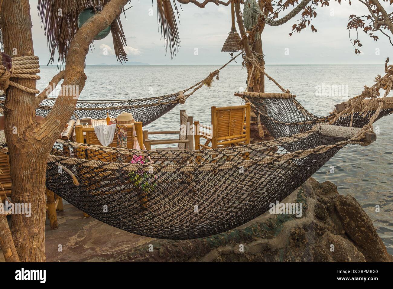 Hamacs suspendus sur une falaise dans un restaurant thaïlandais et une table avec accessoires féminins, Haad son, Koh Pangan, Thaïlande, 08 mai 2016, Banque D'Images