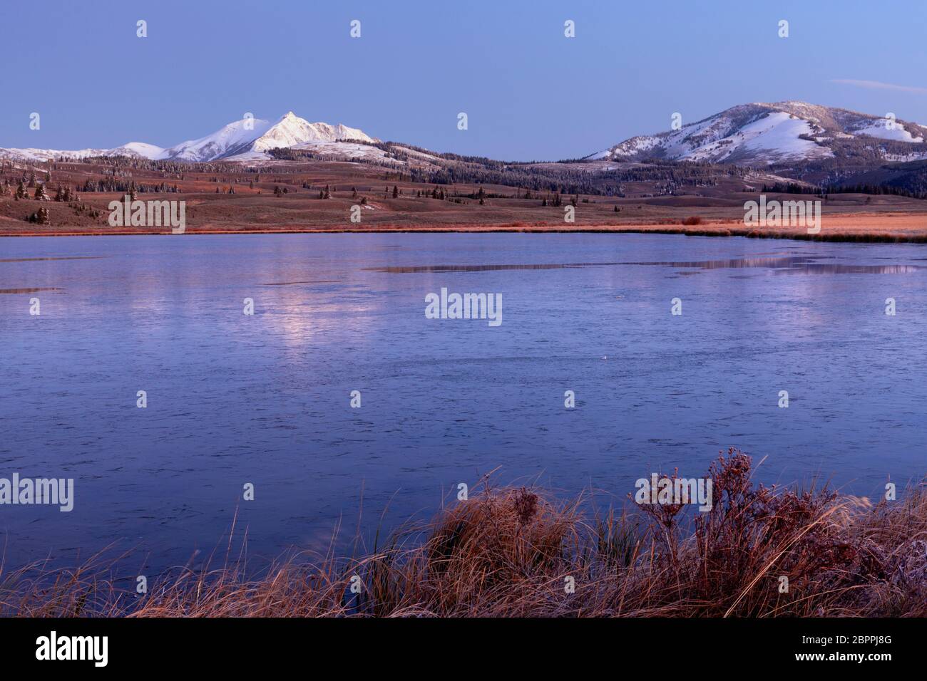 WY04441-00...WYOMING - lever de soleil d'automne au lac Swan partiellement gelé avec les sommets enneigés d'Electric Peak et de Bunsen Peak Beyond à Yell Banque D'Images