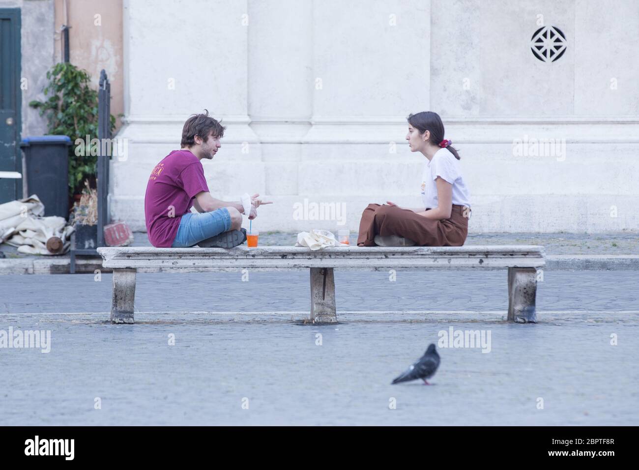 Roma, Italie. 19 mai 2020. Un garçon et une fille assis sur un banc à Piazza NavonaSome restaurants dans le centre de Rome ont rouvert après le décret du gouvernement italien. Certains ont également commencé à faire un apéritif. (Photo de Matteo Nardone/Pacific Press) crédit: Agence de presse du Pacifique/Alamy Live News Banque D'Images