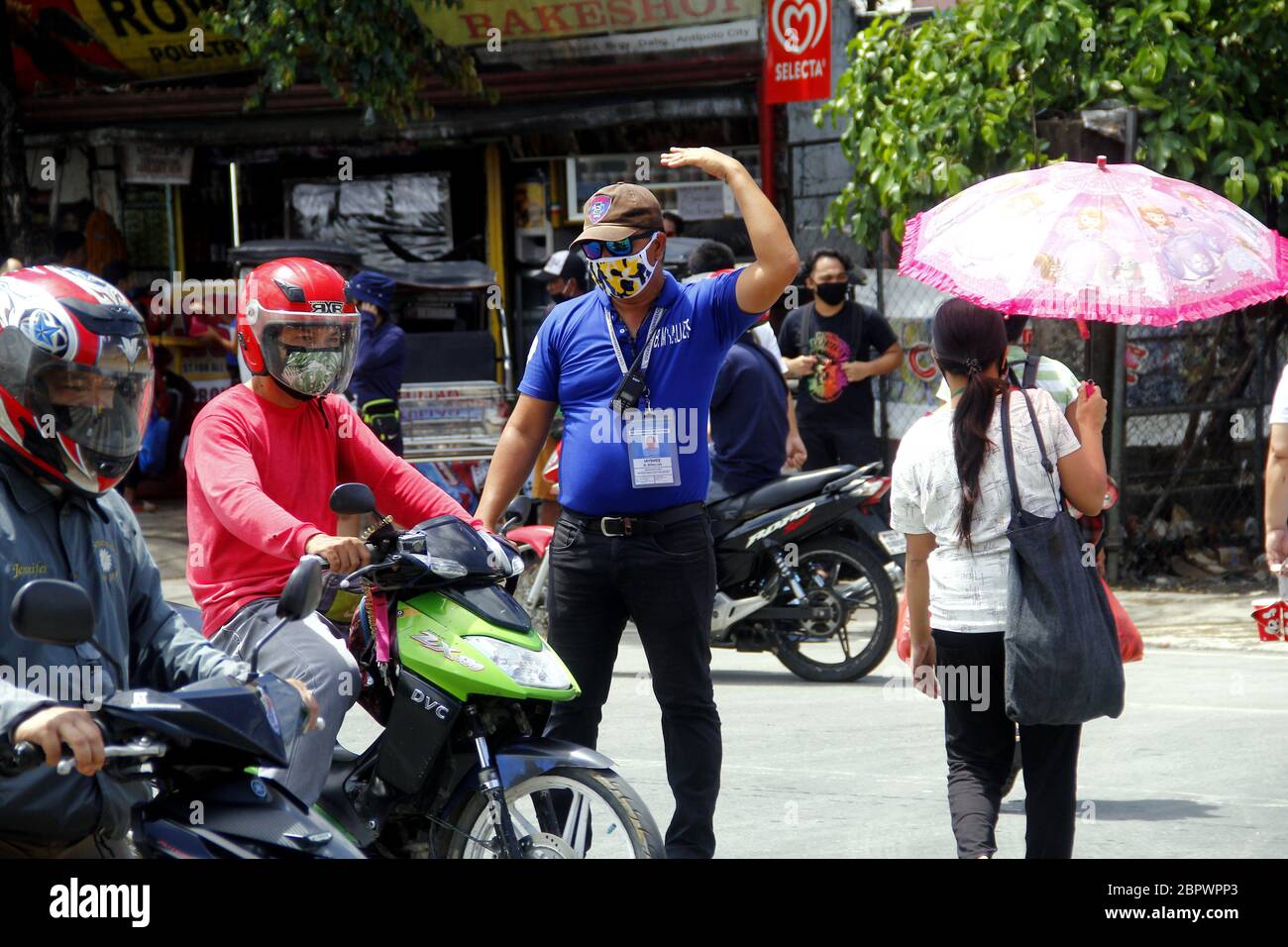 Antipolo City, Philippines - 16 mai 2020 : un policier aide les piétons après que les règles de quarantaine ont été assouplies après un quar communautaire amélioré de deux mois Banque D'Images